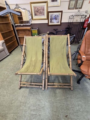 Lot 110 - A pair of bamboo deck chairs with distressed...