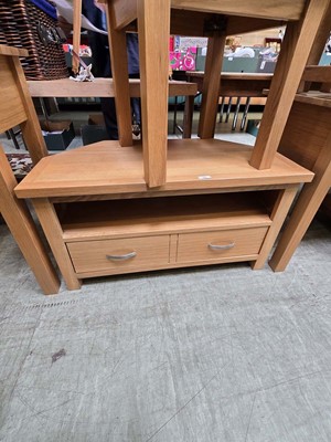 Lot 96 - A modern oak corner TV stand having open...