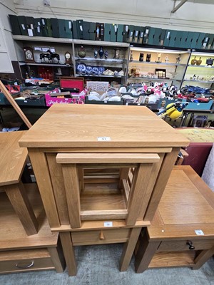 Lot 97 - A modern nest of three oak tables