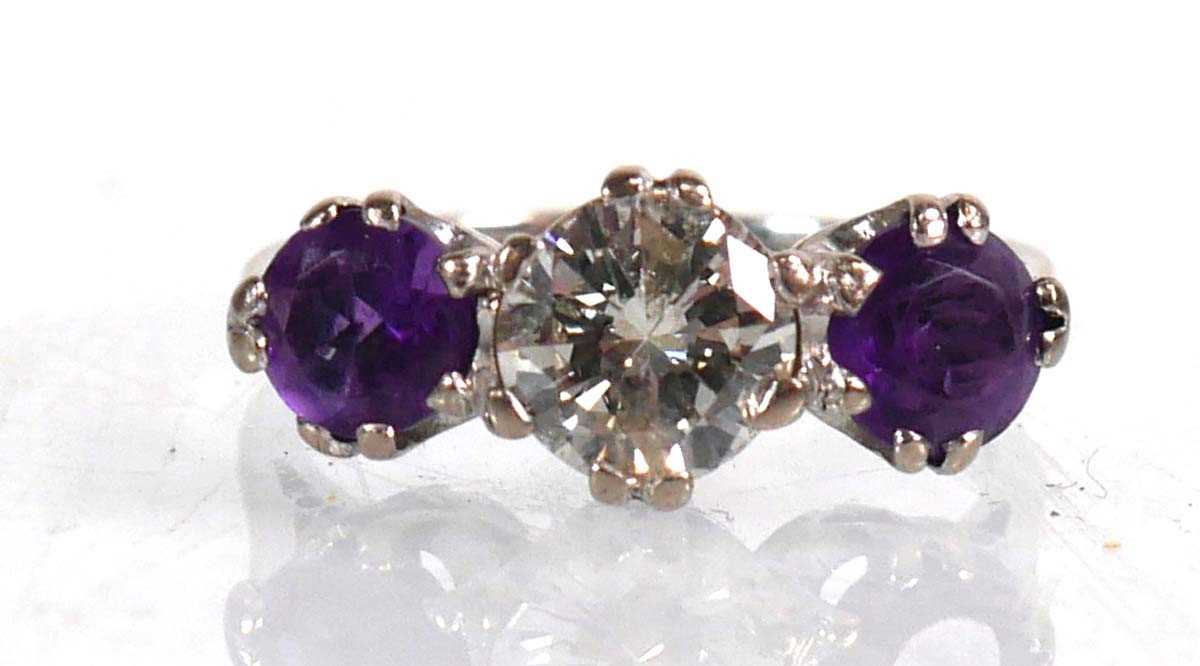 Lot 737 - An 18ct white gold ring set diamond and two...