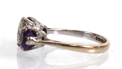 Lot 737 - An 18ct white gold ring set diamond and two...