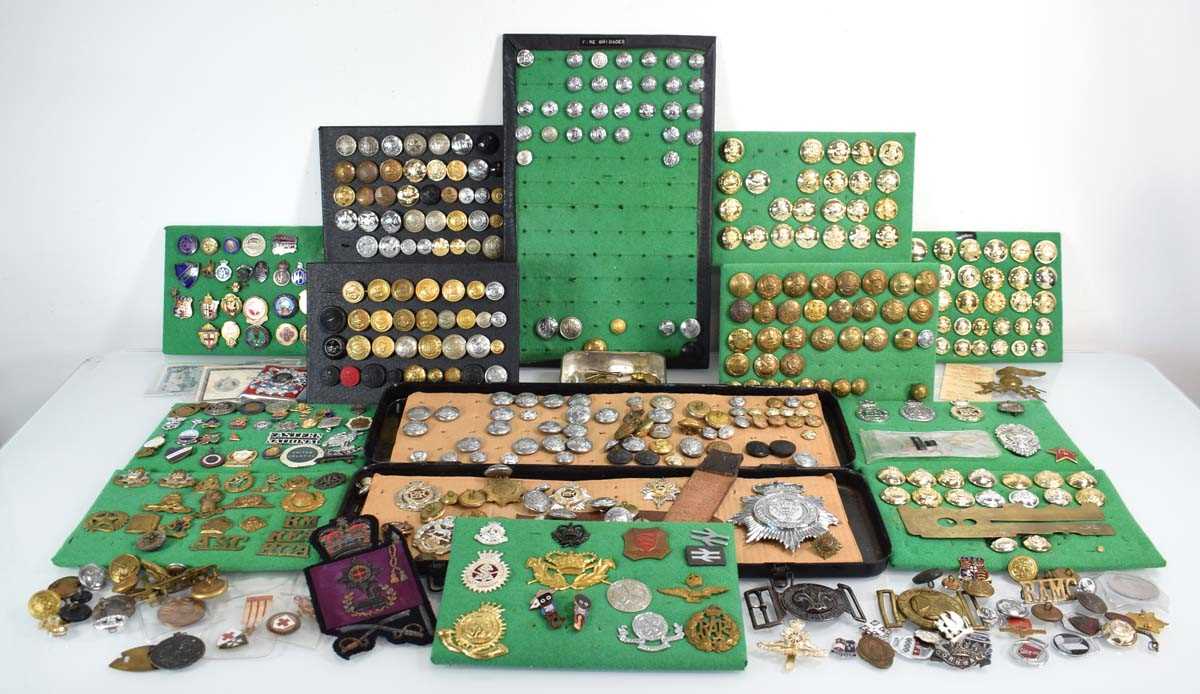 Lot 108 - A collection of buttons, badges, belt buckles,...
