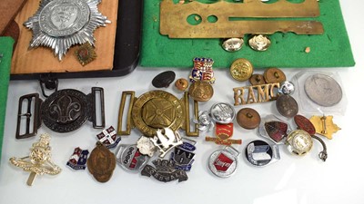 Lot 108 - A collection of buttons, badges, belt buckles,...