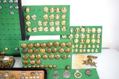 Lot 108 - A collection of buttons, badges, belt buckles,...