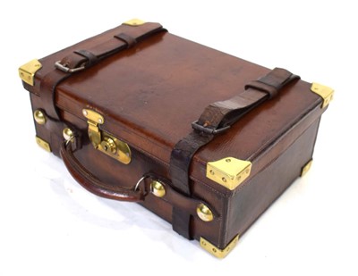 Lot 13 - A leather cartridge case with brass fittings,...