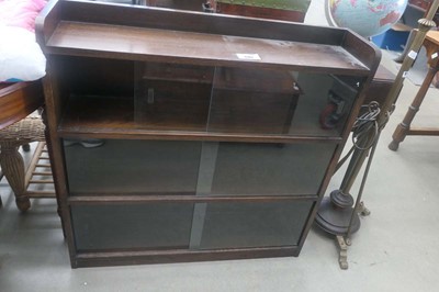 Lot 5102 - Dark oak three tiered bookcase with sliding doors