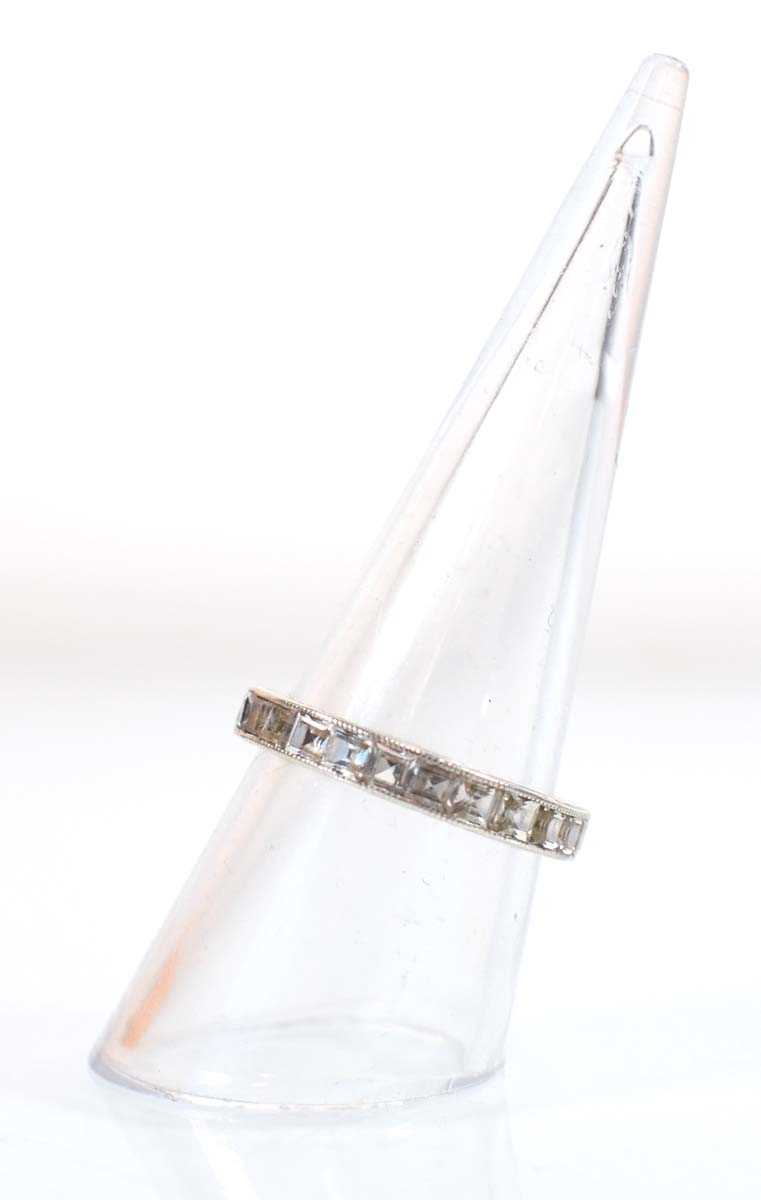 Lot 501 - A white metal full eternity ring set princess...