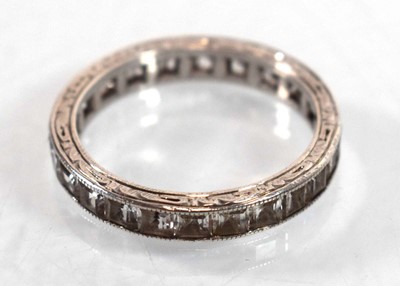 Lot 501 - A white metal full eternity ring set princess...