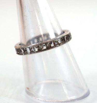 Lot 501 - A white metal full eternity ring set princess...