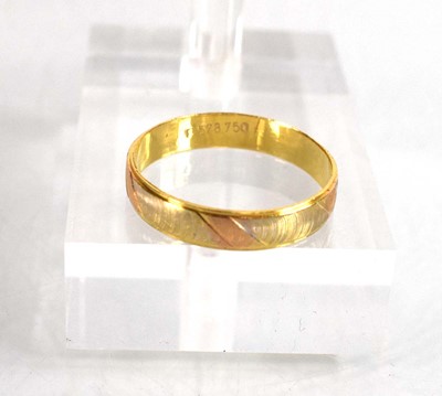 Lot 506 - A tri-colour metal wedding band with engraved...