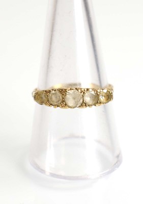 Lot 509 - A yellow metal ring set five graduated clear...