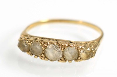Lot 509 - A yellow metal ring set five graduated clear...