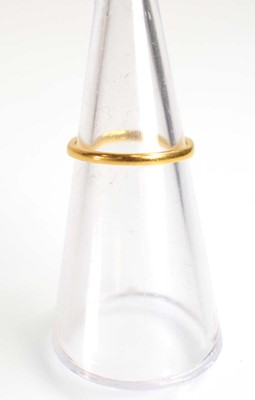 Lot 510 - A 22ct yellow gold wedding band, London 1934,...