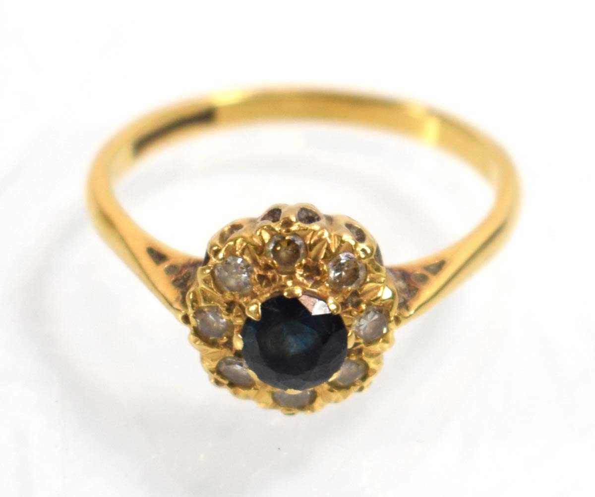 Lot 512 - An 18ct yellow gold cluster ring set sapphire...
