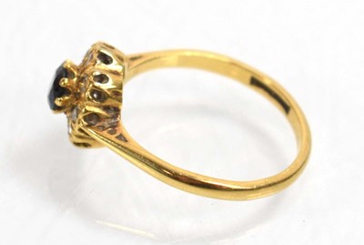 Lot 512 - An 18ct yellow gold cluster ring set sapphire...