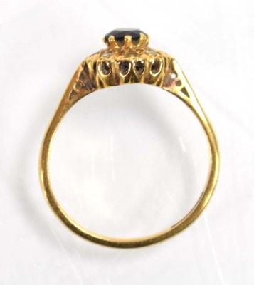 Lot 512 - An 18ct yellow gold cluster ring set sapphire...