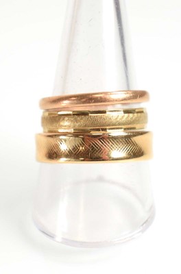 Lot 515 - Two 9ct yellow gold wedding bands and a yellow...
