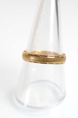 Lot 515 - Two 9ct yellow gold wedding bands and a yellow...