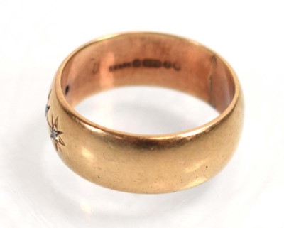 Lot 518 - A 9ct yellow gold band ring set three small...