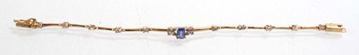 Lot 521 - A yellow metal tennis type bracelet set small...