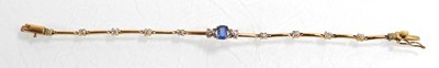 Lot 521 - A yellow metal tennis type bracelet set small...