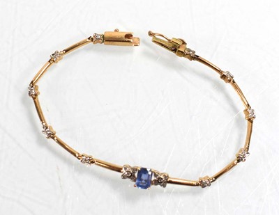 Lot 521 - A yellow metal tennis type bracelet set small...