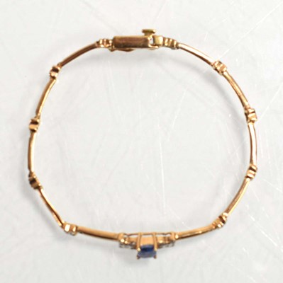 Lot 521 - A yellow metal tennis type bracelet set small...