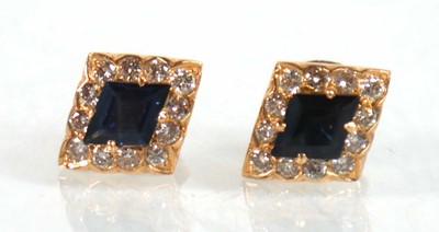 Lot 524 - A pair of yellow metal ear studs, each set a...