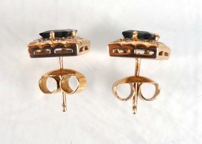 Lot 524 - A pair of yellow metal ear studs, each set a...