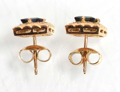 Lot 524 - A pair of yellow metal ear studs, each set a...