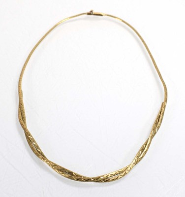 Lot 534 - A 9ct yellow gold engraved articulated...