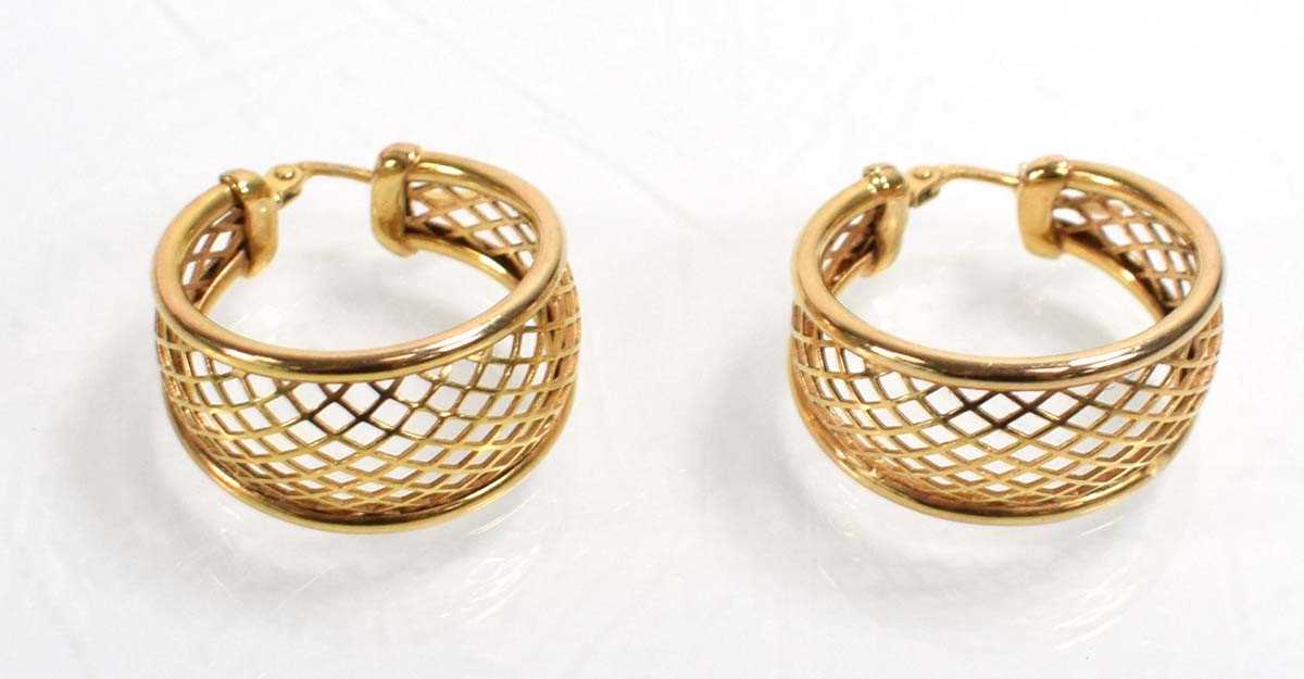 Lot 542 - A pair of 9ct yellow gold ear hoops of trellis...