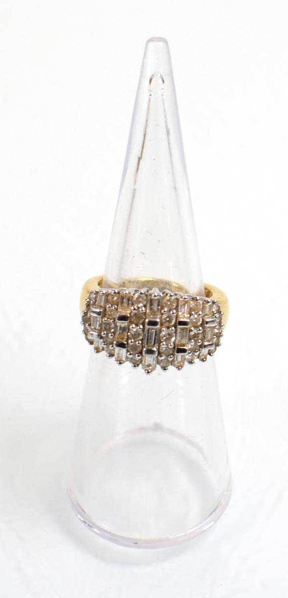 Lot 544 - An 18ct yellow gold ring set eleven rows of...