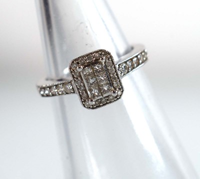 Lot 545 - A 9ct white gold halo type ring set small...