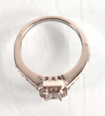 Lot 545 - A 9ct white gold halo type ring set small...