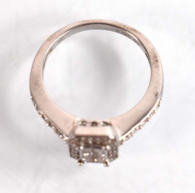 Lot 545 - A 9ct white gold halo type ring set small...