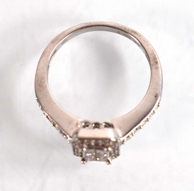 Lot 545 - A 9ct white gold halo type ring set small...