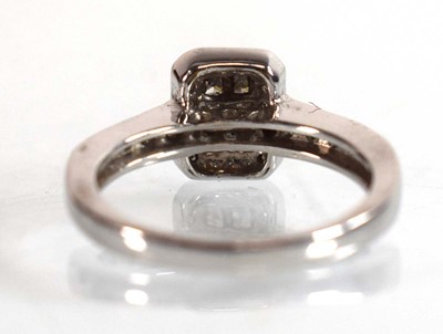 Lot 545 - A 9ct white gold halo type ring set small...