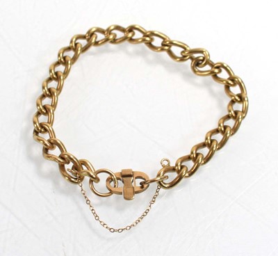 Lot 551 - A 9ct yellow gold curblink bracelet with pigs...