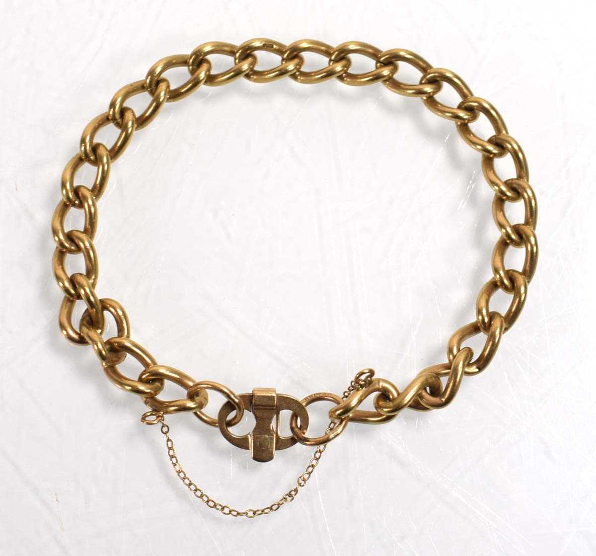 Lot 551 - A 9ct yellow gold curblink bracelet with pigs...