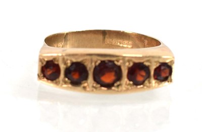 Lot 554 - A 9ct yellow gold ring set five graduated...