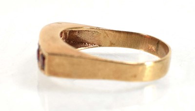 Lot 554 - A 9ct yellow gold ring set five graduated...