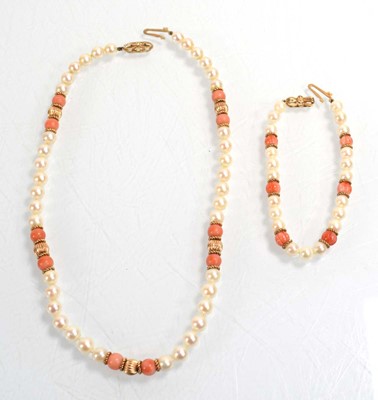 Lot 555 - A single strand cultured pearl and coral bead...