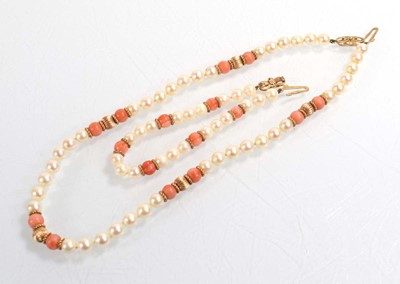 Lot 555 - A single strand cultured pearl and coral bead...