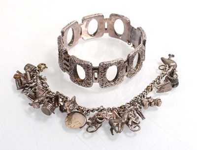 Lot 556 - A silver curblink bracelet suspending a...