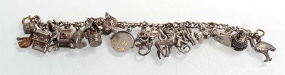 Lot 556 - A silver curblink bracelet suspending a...