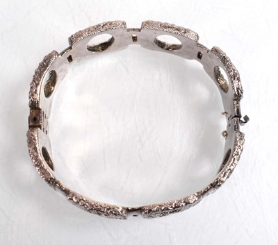 Lot 556 - A silver curblink bracelet suspending a...
