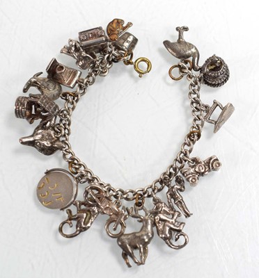 Lot 556 - A silver curblink bracelet suspending a...