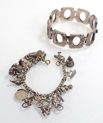 Lot 556 - A silver curblink bracelet suspending a...