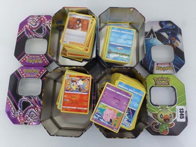 Lot 4 tins of assorted Pokémon cards